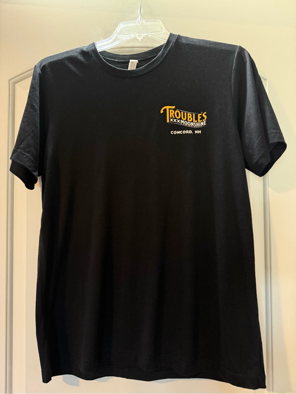 Steadfast Distillery Black Short Sleeve Tee with Trouble's Moonshine logo